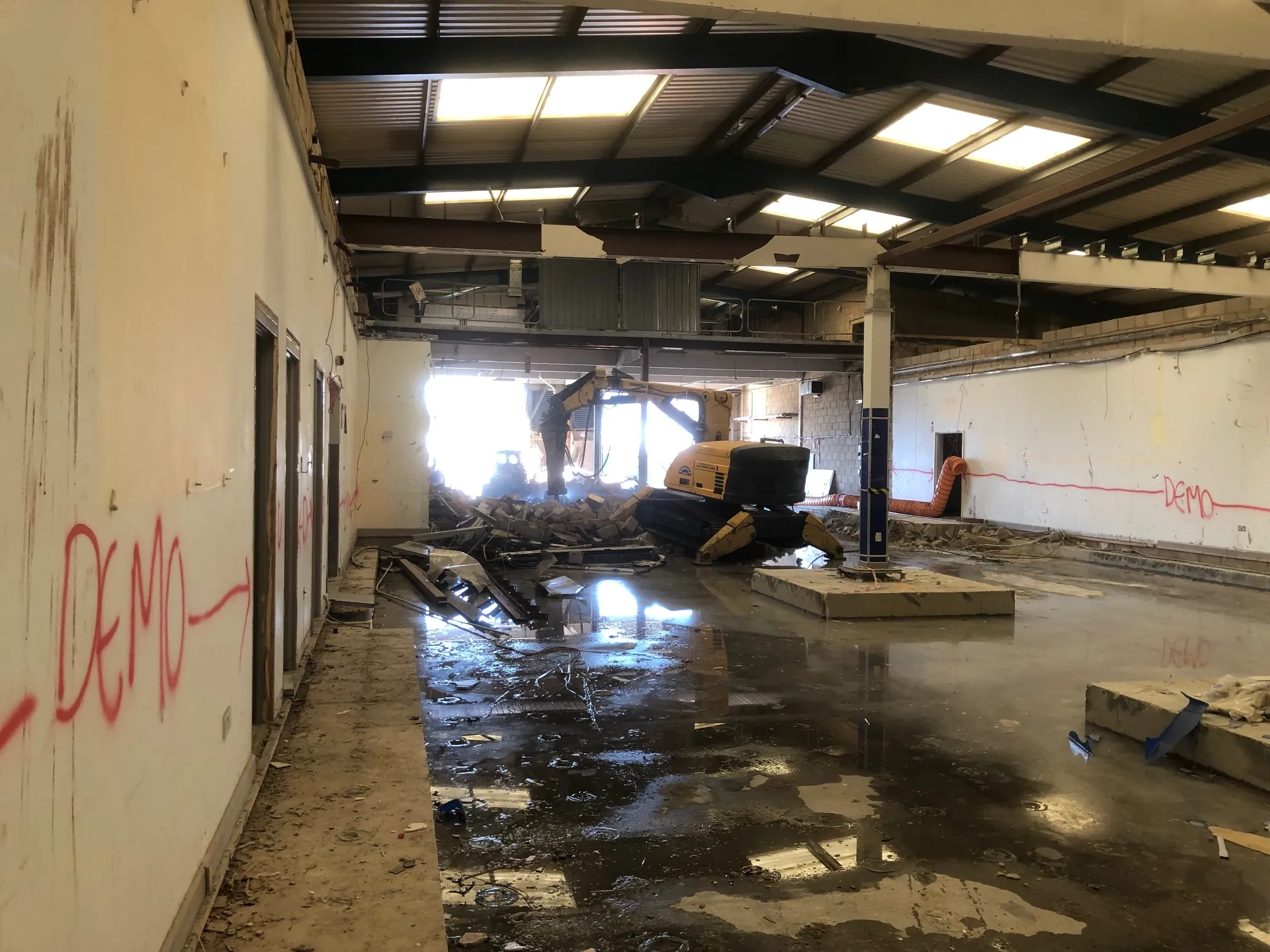 Demolition contractor removing reinforced walls