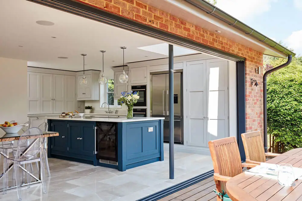 New kitchen with wooden units opening onto a garden